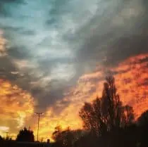 A photo of clouds on a red and blue sky at night