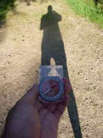 shadow of tristan holding a compass